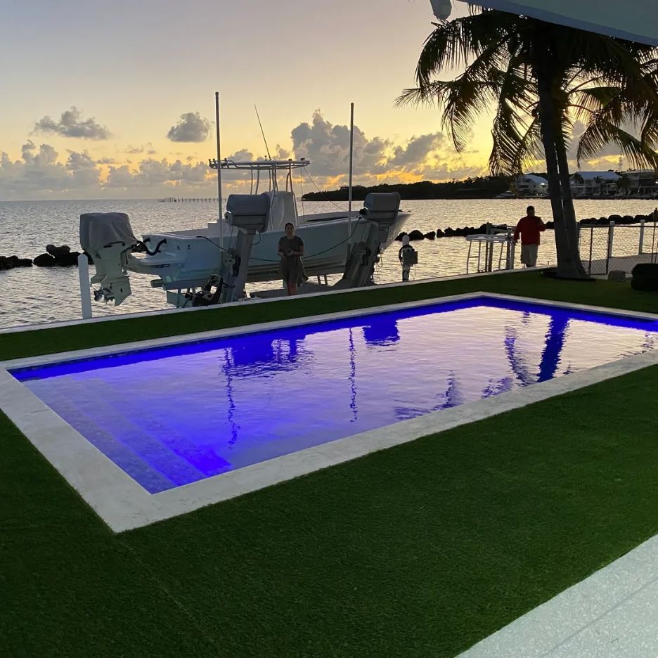 Waterfront pool with evening lighting